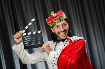 King with movie board in funny concept