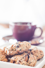 Closeup cereal cookies with violet coffee cup