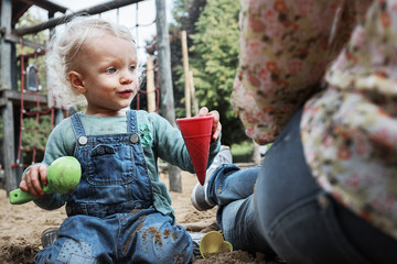 Little girl playing in the sandpit