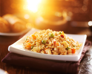 chinese fried rice on plate with orange glow