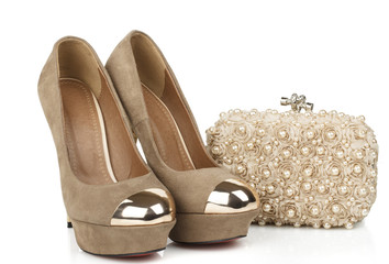 isolated women beige suede shoes with clutch bag