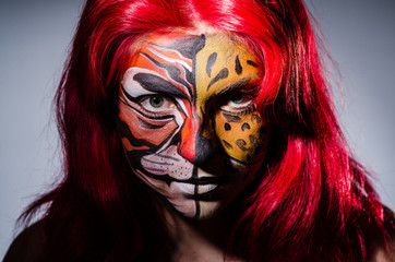 Woman with tiger face in halloween concept