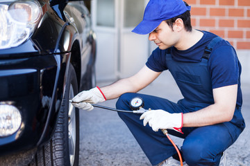 Mechanic inflating a tire