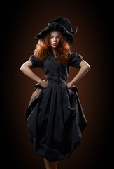 beautiful red-haired girl in the witch costume