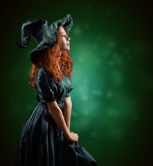 beautiful red-haired girl in  costumes witch