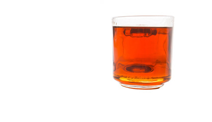 Honey in glass jar over white background