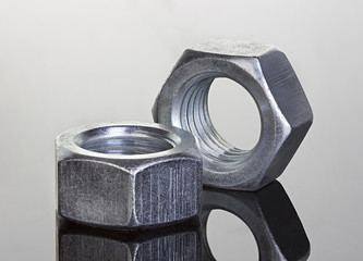 Metal nuts on black background