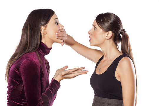 young woman covering the mouth of her mate