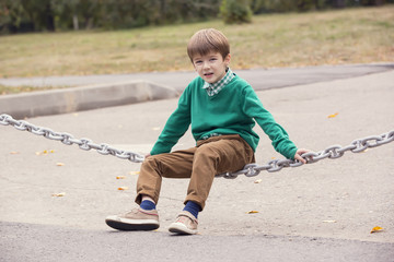 Portrait of a boy on a background of green nature