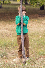 Portrait of a boy on a background of green nature