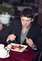 young man having dinner in a restaurant