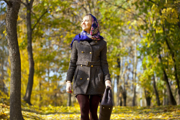 Young woman walking in autumn park