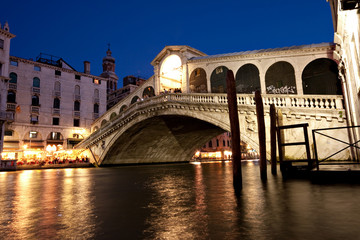 The Rialto Bridge, a famous Venice landmark, at night.