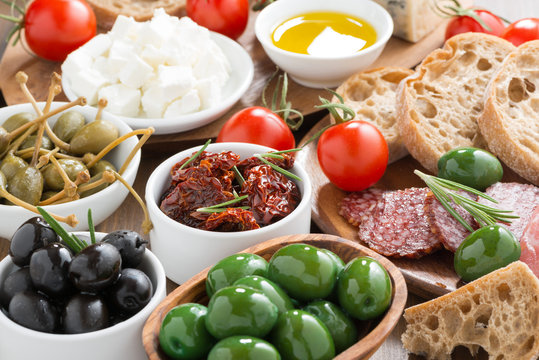 assorted Italian antipasti - olives, salami, pickles and bread