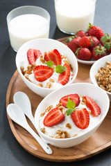 healthy breakfast - yogurt, fresh strawberries, granola and milk