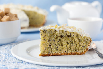 Delicious poppy seed cake with cup of tea on table close-up