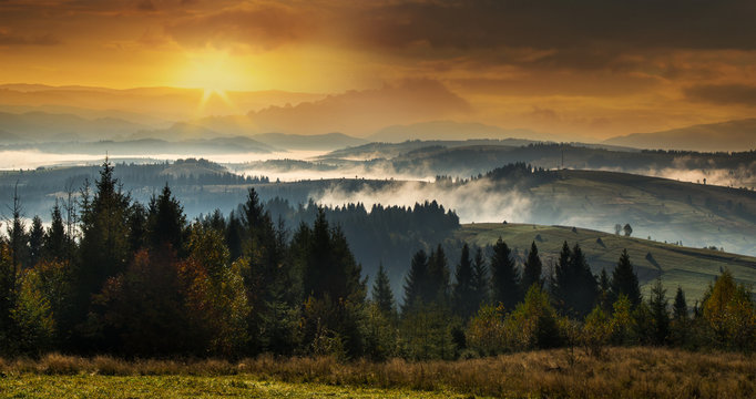 Mountains at sunset with a dense fog