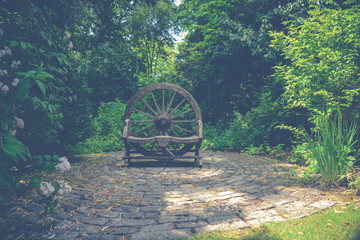 Wooden wheel ornament in Cornish garden