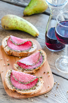 Slices of italian salami with pears and wine
