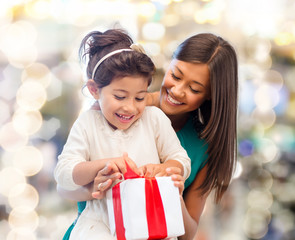 happy mother and little girl with gift box