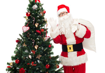 santa claus with bag and christmas tree