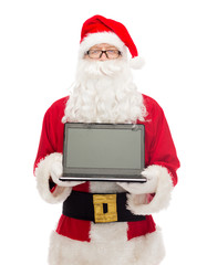 man in costume of santa claus with laptop