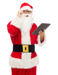 man in costume of santa claus with tablet pc