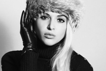 Monochrome portrait.Young Woman in Fur Hat.Black Leather Gloves