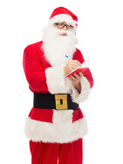 man in costume of santa claus with notepad