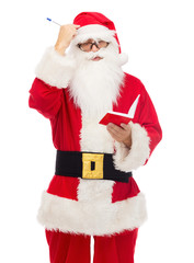 man in costume of santa claus with notepad