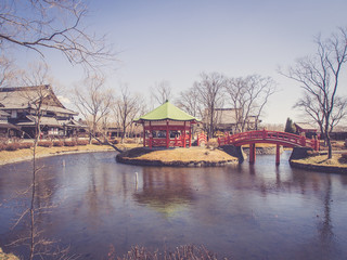 bridge and pavilion in japanese garden in spring