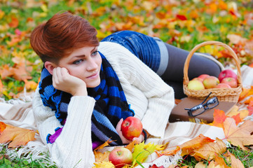 Young pretty woman relaxing in the autumn park