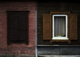 Obraz na płótnie Canvas The old shabby wood closed and opened windows with shutters