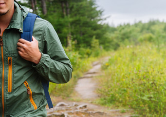 Fototapeta premium Hiker man walking on path in summer