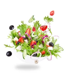 Schilderijen op glas Fresh salad with flying vegetables ingredients © Lukas Gojda