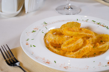 Bowl of Onion Rings at Fancy Table Setting