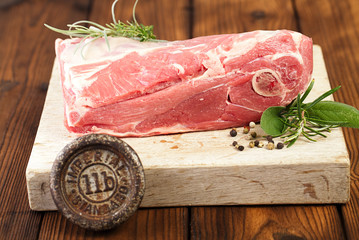 raw shoulder lamb on wooden board and table © Elena Moiseeva