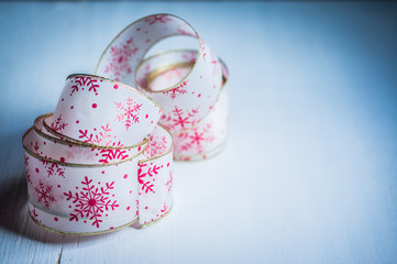 Holiday ribbon on wooden background