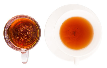 A cup of tea and a jar of honey over white background