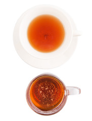 A cup of tea and a jar of honey over white background