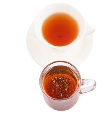 A cup of tea and a jar of honey over white background