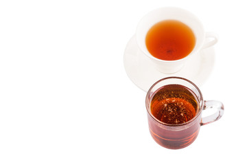 A cup of tea and a jar of honey over white background