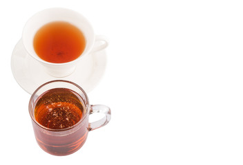 A cup of tea and a jar of honey over white background