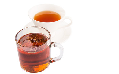 A cup of tea and a jar of honey over white background