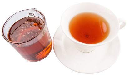 A cup of tea and a jar of honey over white background