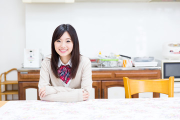 young asian woman relaxing in the kitchen