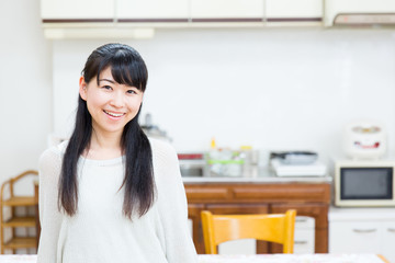 young asian women relaxing in the kitchen