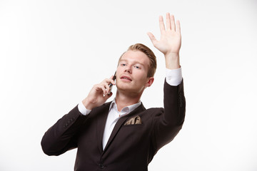 businessman in glasses with a telephone waving