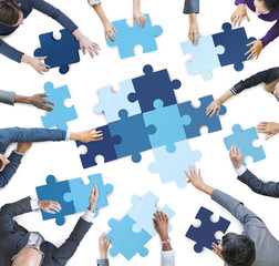 Business People Piecing Puzzle Pieces