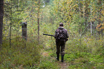 hunter shooting on the walk in forest